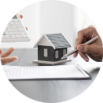 A real estate agent and a client review property listings together at a desk